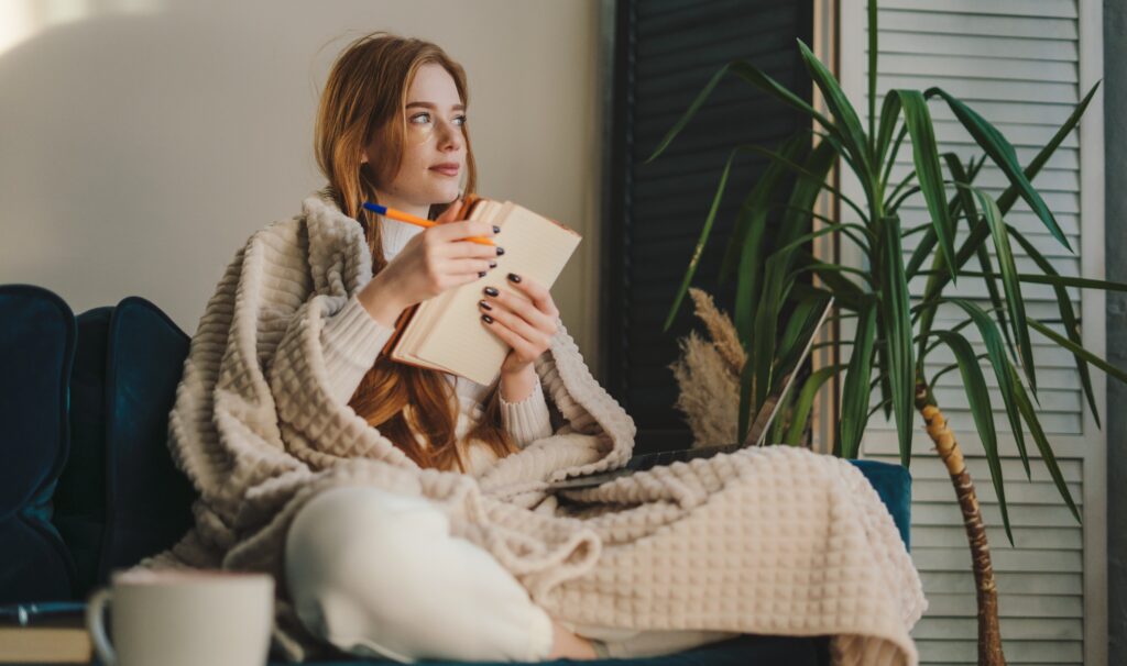 woman writing to illustrate the article From Soul to Page: How to Get to The Heart of Your Writing