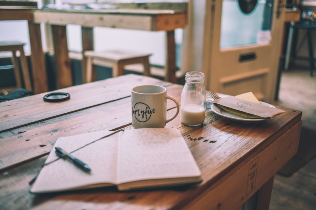 woman journalling as a visual guide for the article Visulisation vs. Affirmation